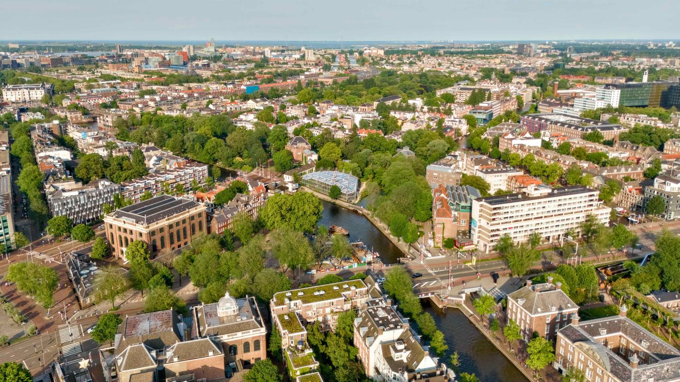 Luchtfoto van Amsterdamse grachten, parken en daken